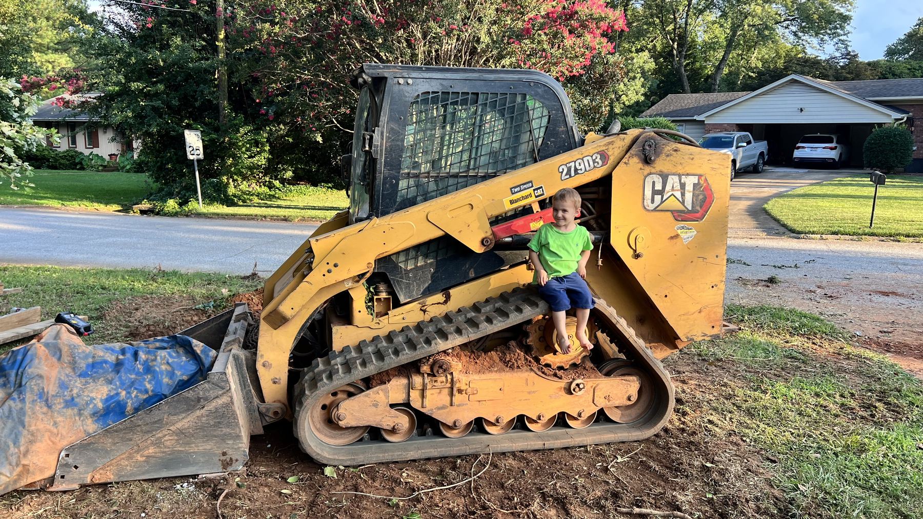 Small Boy sitting on skid-steer tractor